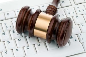 Gavel and keyboard. Legal certainty on the web. Web Auction.